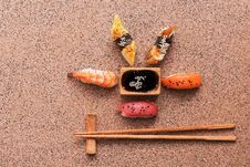 Assorted Sushi Set On A Brown Stone Background. Japanese Food Sushi, Soy Sauce, Chopsticks. Top View, Copy Space Royalty Free Stock Images