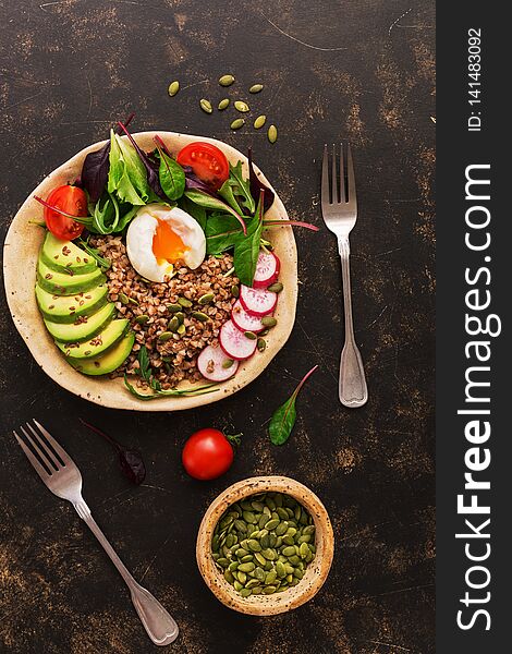 Buckwheat Porridge With Boiled Egg, Avocado, Radish, Chard Leaves, Arugula, Tomatoes And Seeds. Buddha Bowl With Healthy Food. Top