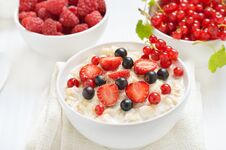Tasty Porridge With Strawberry Slices, Black And Red Currants Stock Images