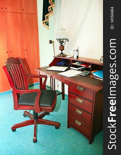 Office furniture, wooden arm-chair and table.