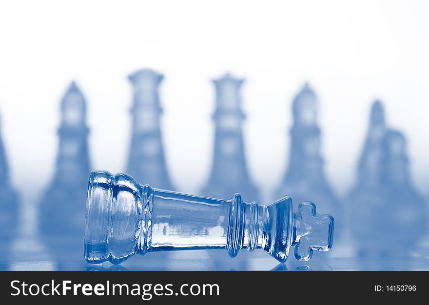 Glass chess pieces with blue light, isolated