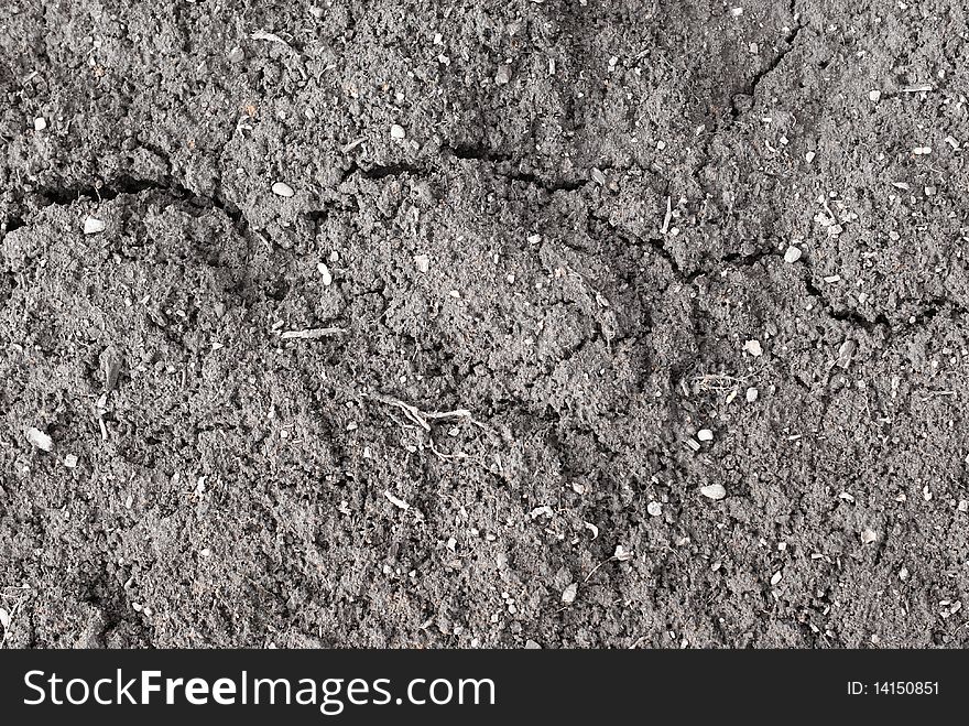 Spring bare soil background with cracks