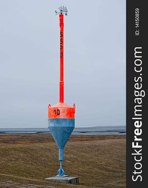 Bright Red Buoy at land in Northern Germany