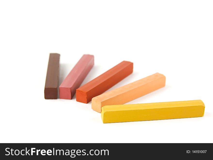 Five colored pastels on a white background