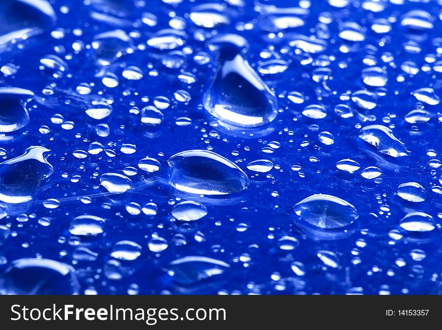 Droplets of water on blue glass