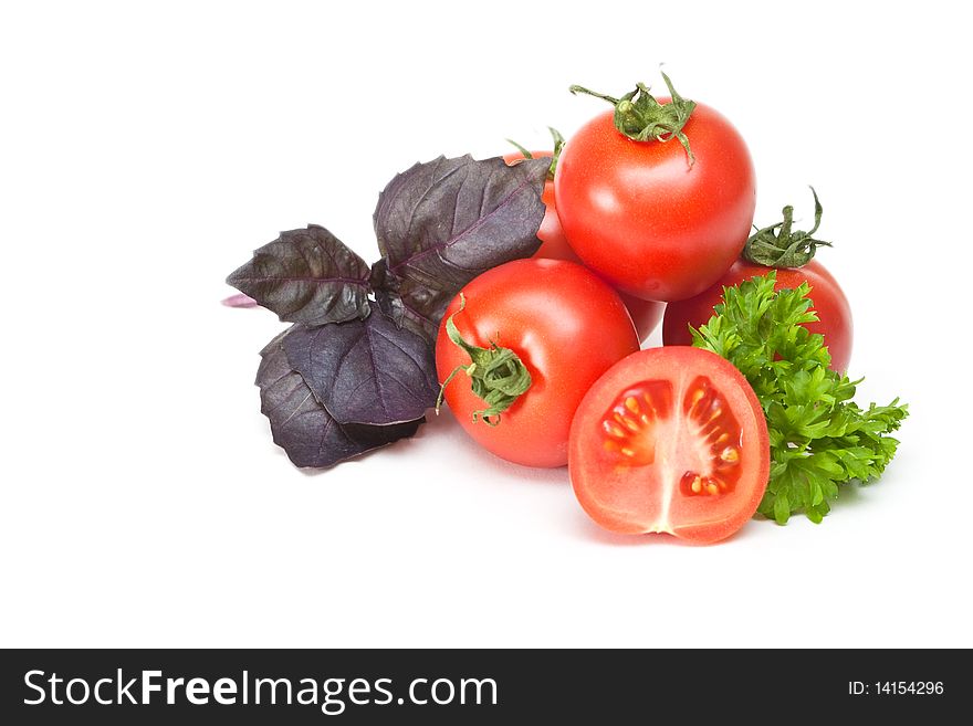 Tomato with parsley and basil on a white background