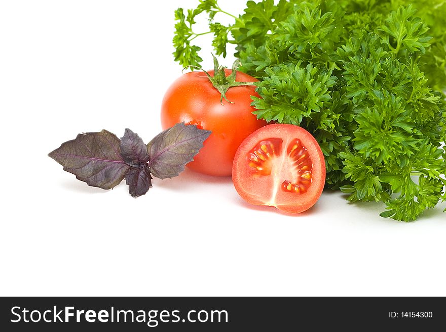 Parsley, basil and tomato on a white background