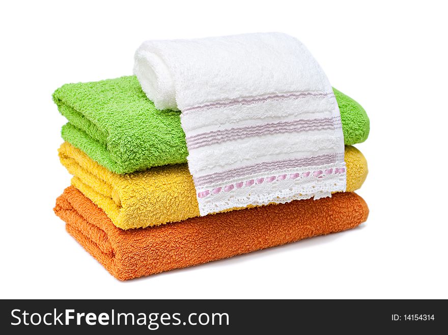 Stacked colorful towels isolated on a white background. Stacked colorful towels isolated on a white background.