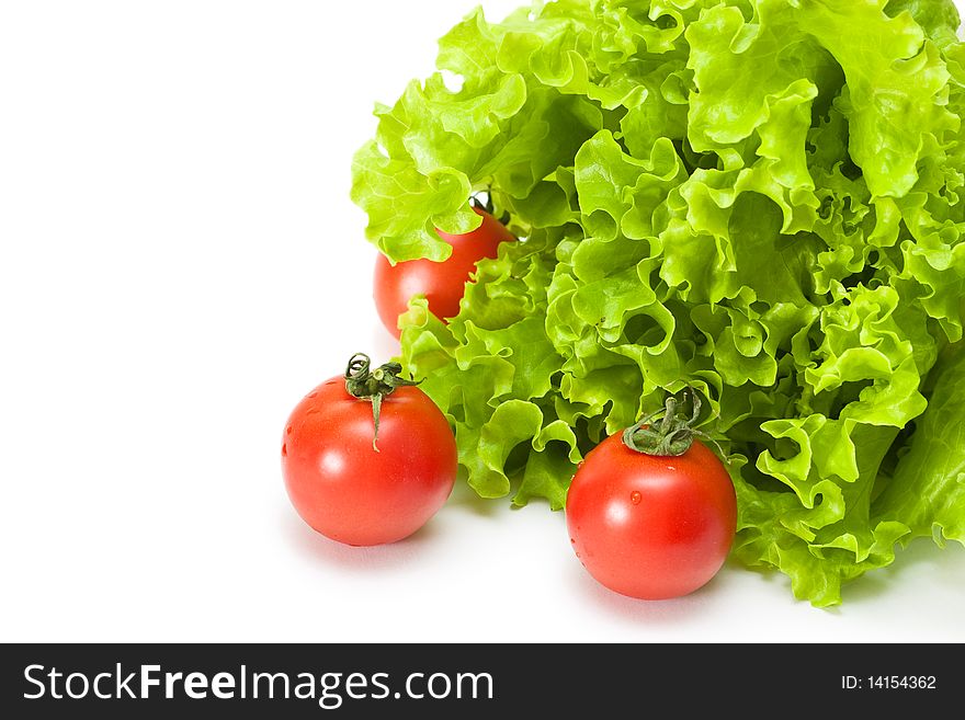 Tomato with salad on a white background. Tomato with salad on a white background