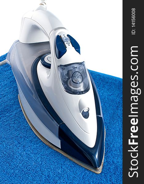 Electric iron on blue towel