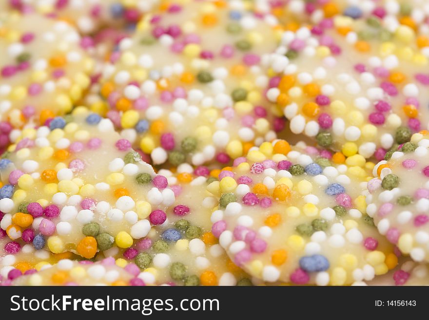 Background of white chocolate buttons with sprinkles