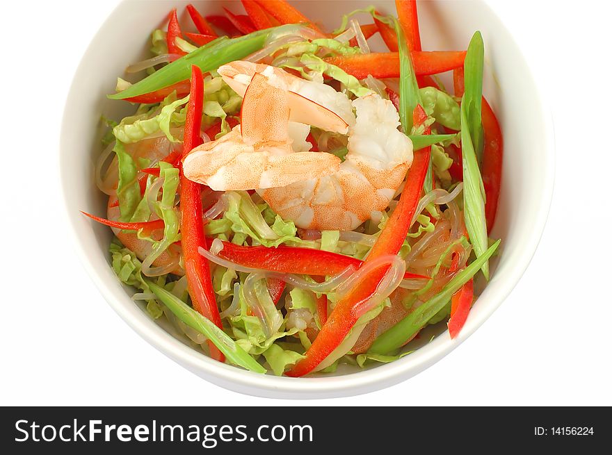 Salad with shrimps in a white plate on a white background