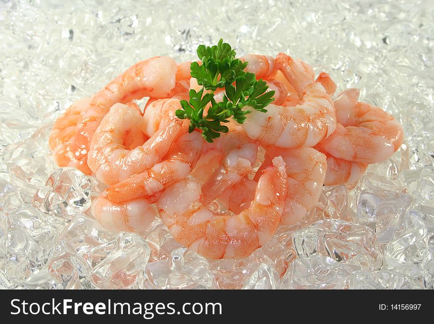 Many fresh, raw shrimp and parsley on ice. Many fresh, raw shrimp and parsley on ice