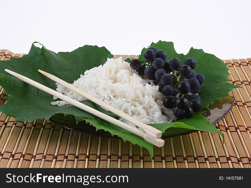 Simple arrangment of chopsticks, rice and grapes. Simple arrangment of chopsticks, rice and grapes