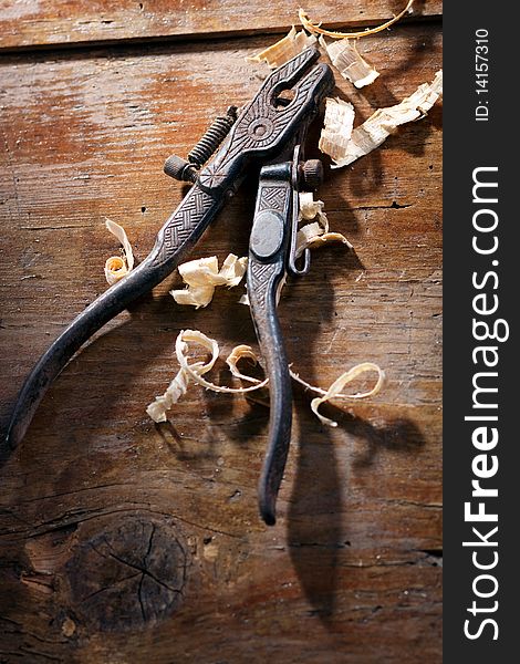 Old hand pliers on wooden background