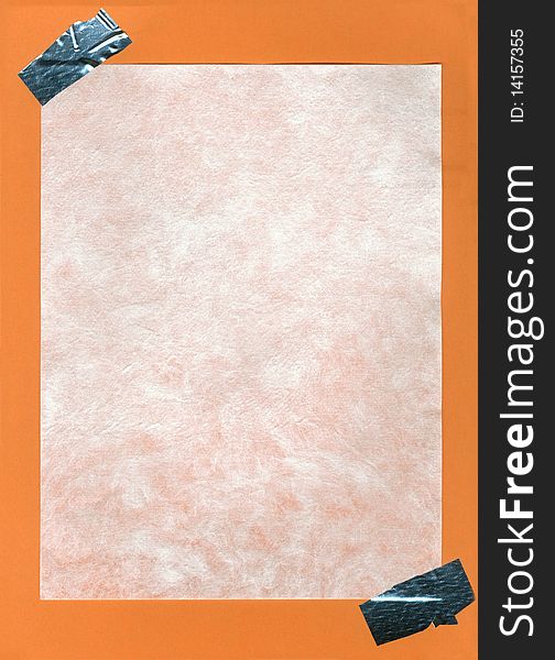 A piece of cotton paper with adhesive corners glued on orange paper