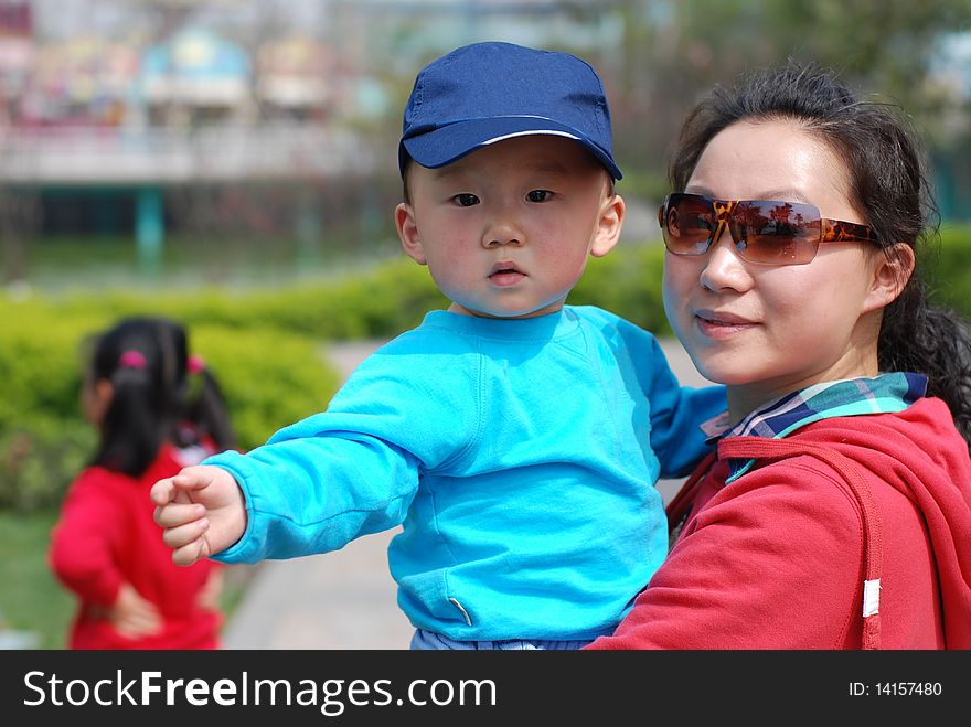 Cute baby boy with his mother in park. Cute baby boy with his mother in park