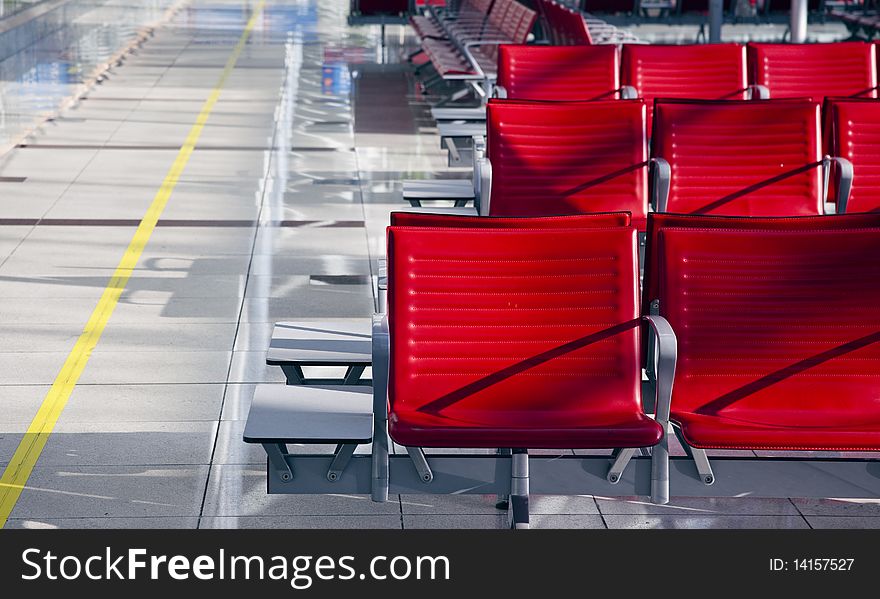 Lot of red seats in the empty airport