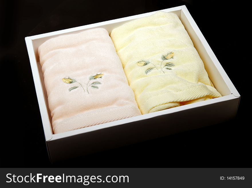 Towels in the box isolated on dark.