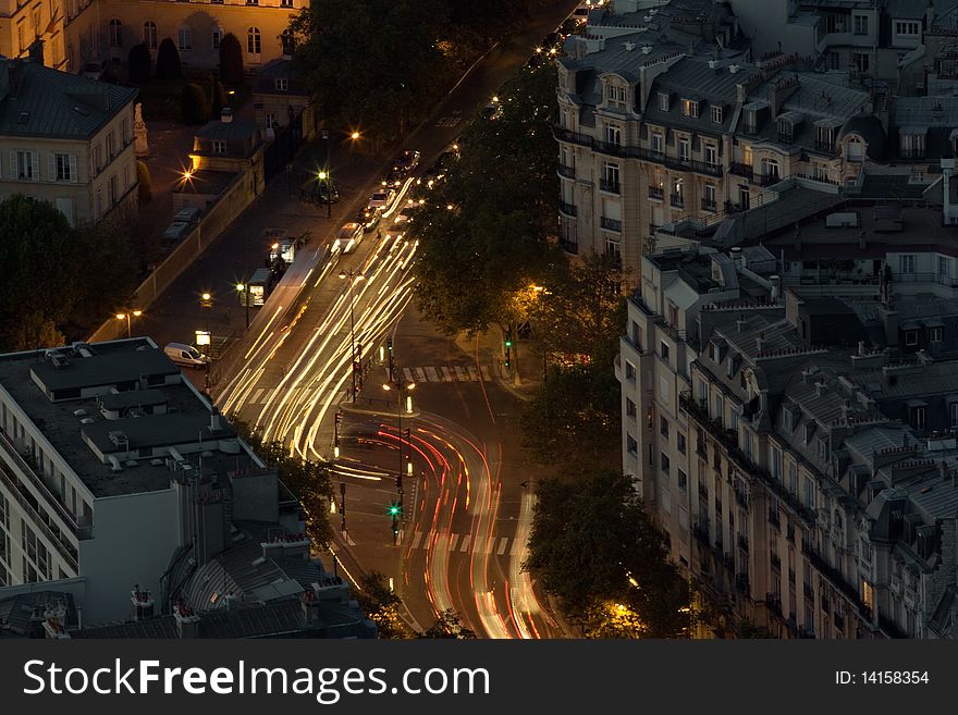 Aerial view of a Paris road intersection at night. Long exposure with car light trails. Aerial view of a Paris road intersection at night. Long exposure with car light trails.