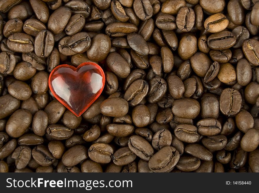 Many coffee beans with red heart. Many coffee beans with red heart