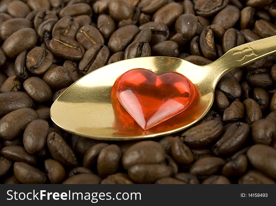 Coffee beans and red heart and golden spoon. Coffee beans and red heart and golden spoon