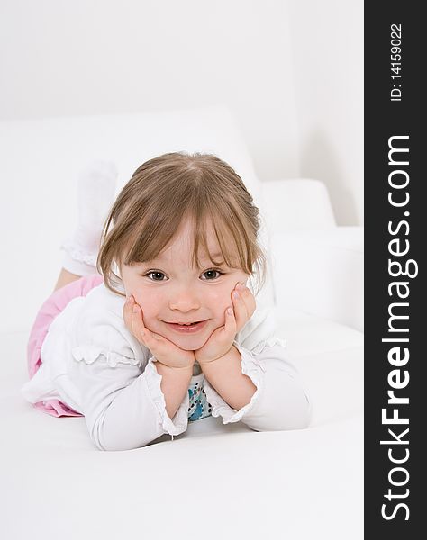 Happy little girl on sofa