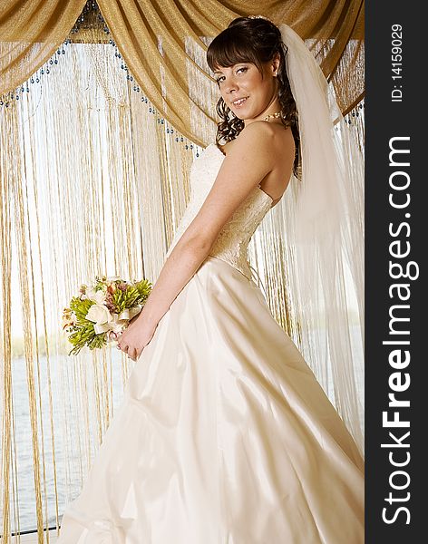 Bride in front of a window , interior shoot