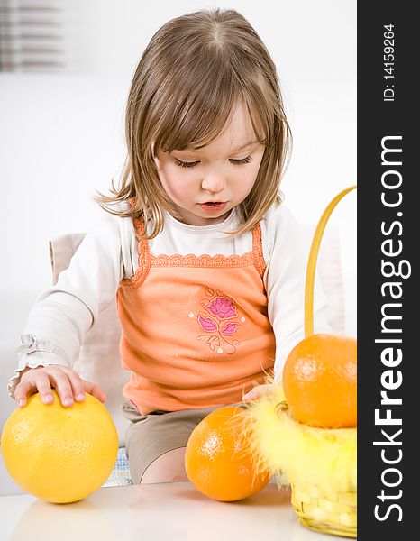 Happy little girl with fruits