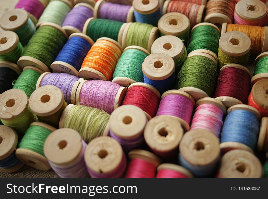 Spools of colored thread. multicolored motley background.