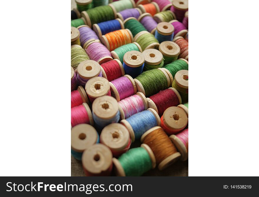 Spools of colored thread. multicolored motley background.