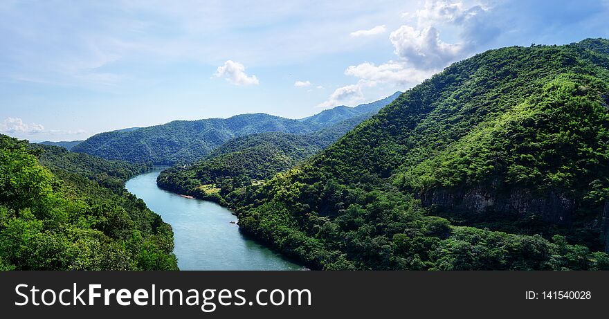 Beautiful panorama: Top view blue river in green mountains valley. Travel, tourism, wanderlust concept. Text space