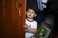 Free Little Boy Hiding Inside Wardrobe Stock Images - 141591514