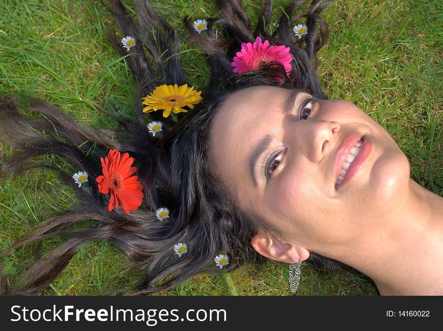 Woman on the grass with flowers in her hair