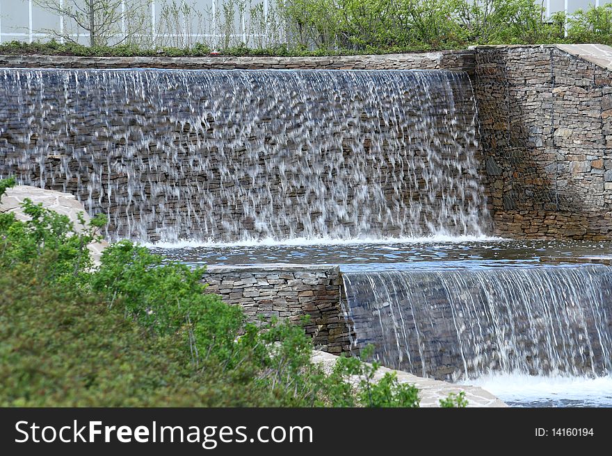 Cascade of artificial waterfalls in the city park