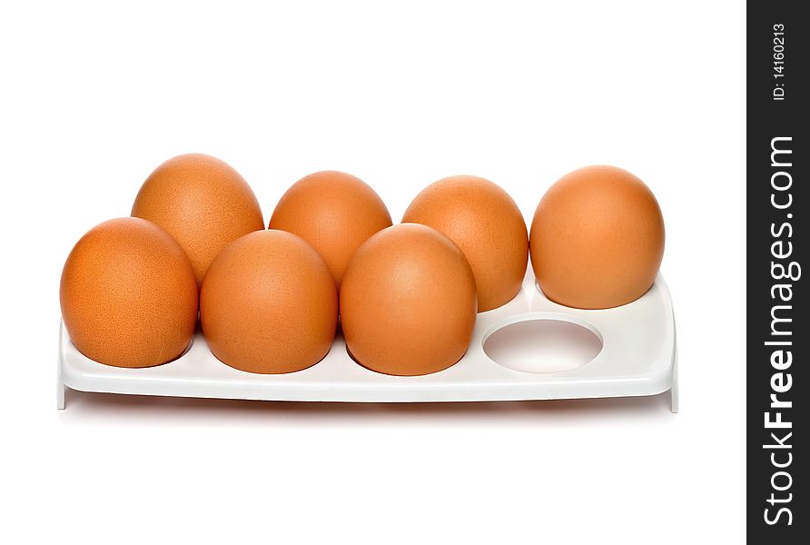 Chicken brown eggs in container isolated on white