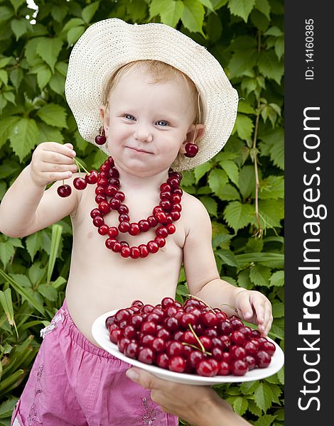 Girl with red cherry beads and earrings