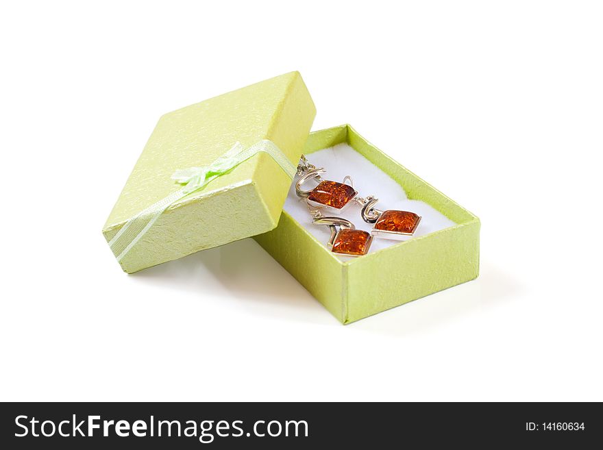 Green gift box with ribbon with jewelry