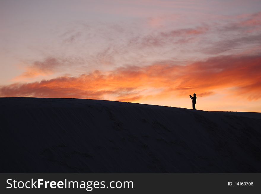 Person on dunes @ White Sands Park, NM @ sunset. Person on dunes @ White Sands Park, NM @ sunset