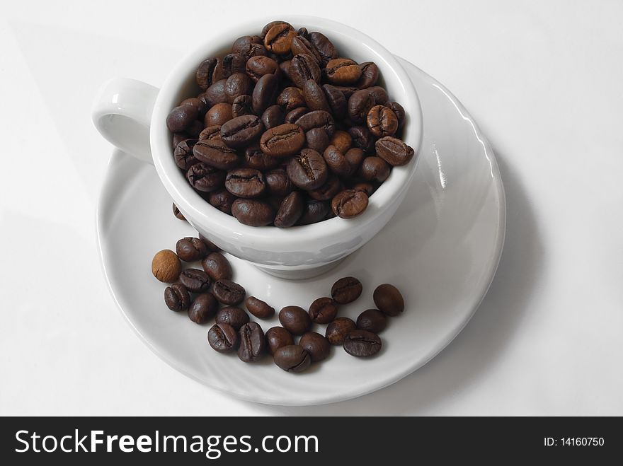 Coffee cup and coffee beans on white background