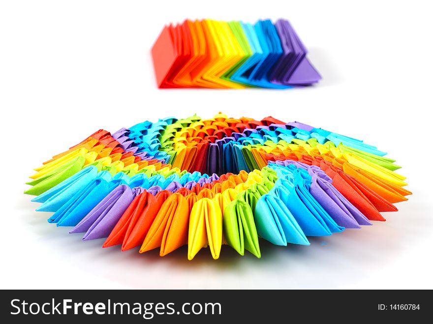 Colorfull origami 3d units like a rainbow circle isolated on white with shadow. From sheets of paper making modules, which joined. Colorfull origami 3d units like a rainbow circle isolated on white with shadow. From sheets of paper making modules, which joined.