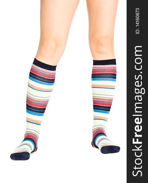 Caucasian woman legs in colorful stripped socks on white isolated background. Caucasian woman legs in colorful stripped socks on white isolated background