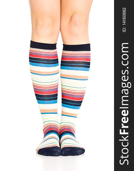 Caucasian woman legs in colorful stripped socks on white isolated background. Caucasian woman legs in colorful stripped socks on white isolated background