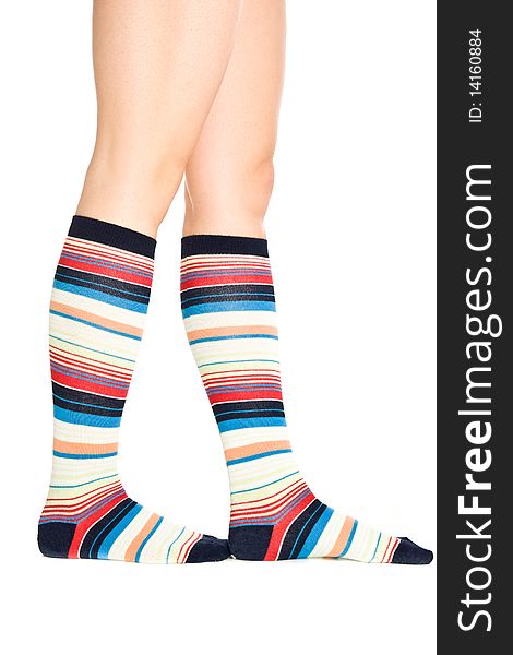 Caucasian woman legs in colorful stripped socks on white isolated background. Caucasian woman legs in colorful stripped socks on white isolated background