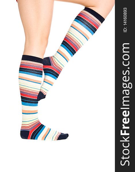 Caucasian woman legs in colorful stripped socks on white isolated background. Caucasian woman legs in colorful stripped socks on white isolated background