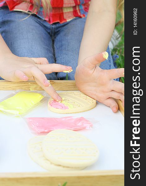 Child frosting cookies vertical