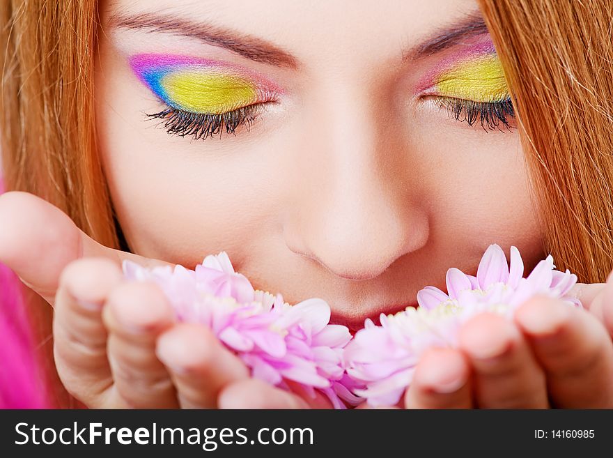 Young pretty girl smelling flower