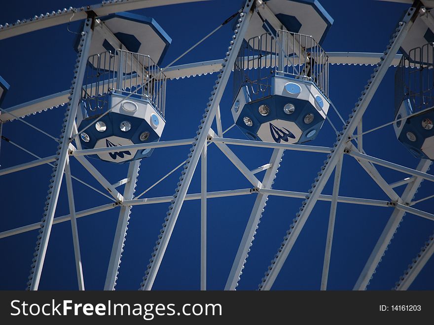 Carts of a ferris wheel up in the sky