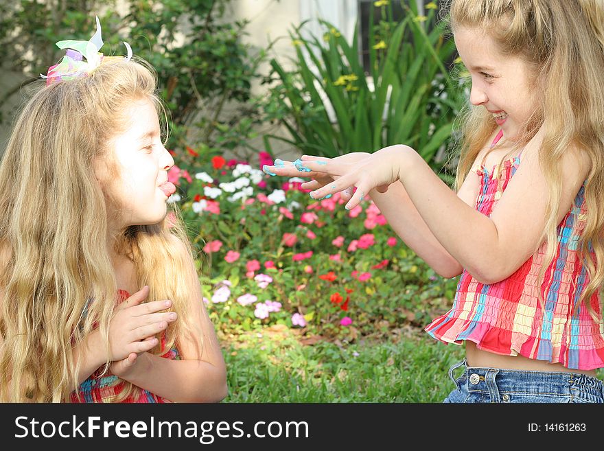 Shot of teasing sisters with sticky fingers