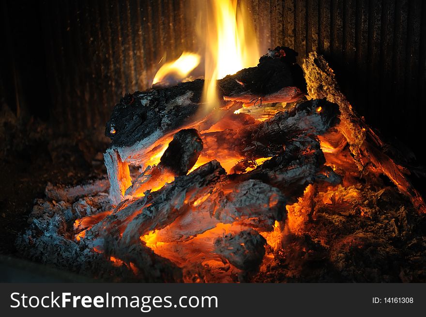 The photo shows a fire in the fireplace. The photo shows a fire in the fireplace